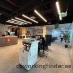 High ceiling coworking office with glass partitions in Dubai