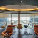 A person checking in at a coworking space reception desk